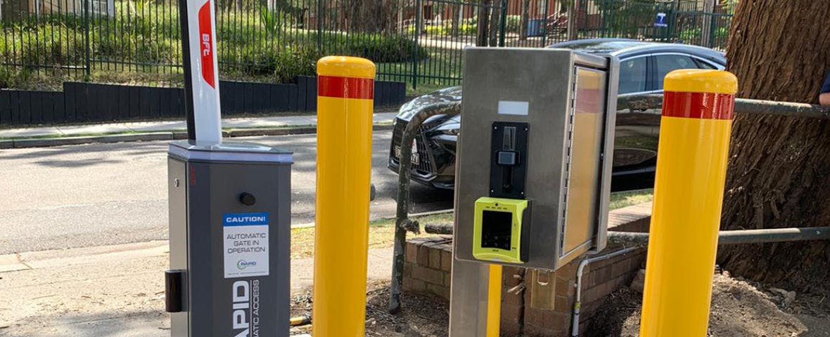 High-traffic volume boom gate with a token and payment system for a hotel car park.
