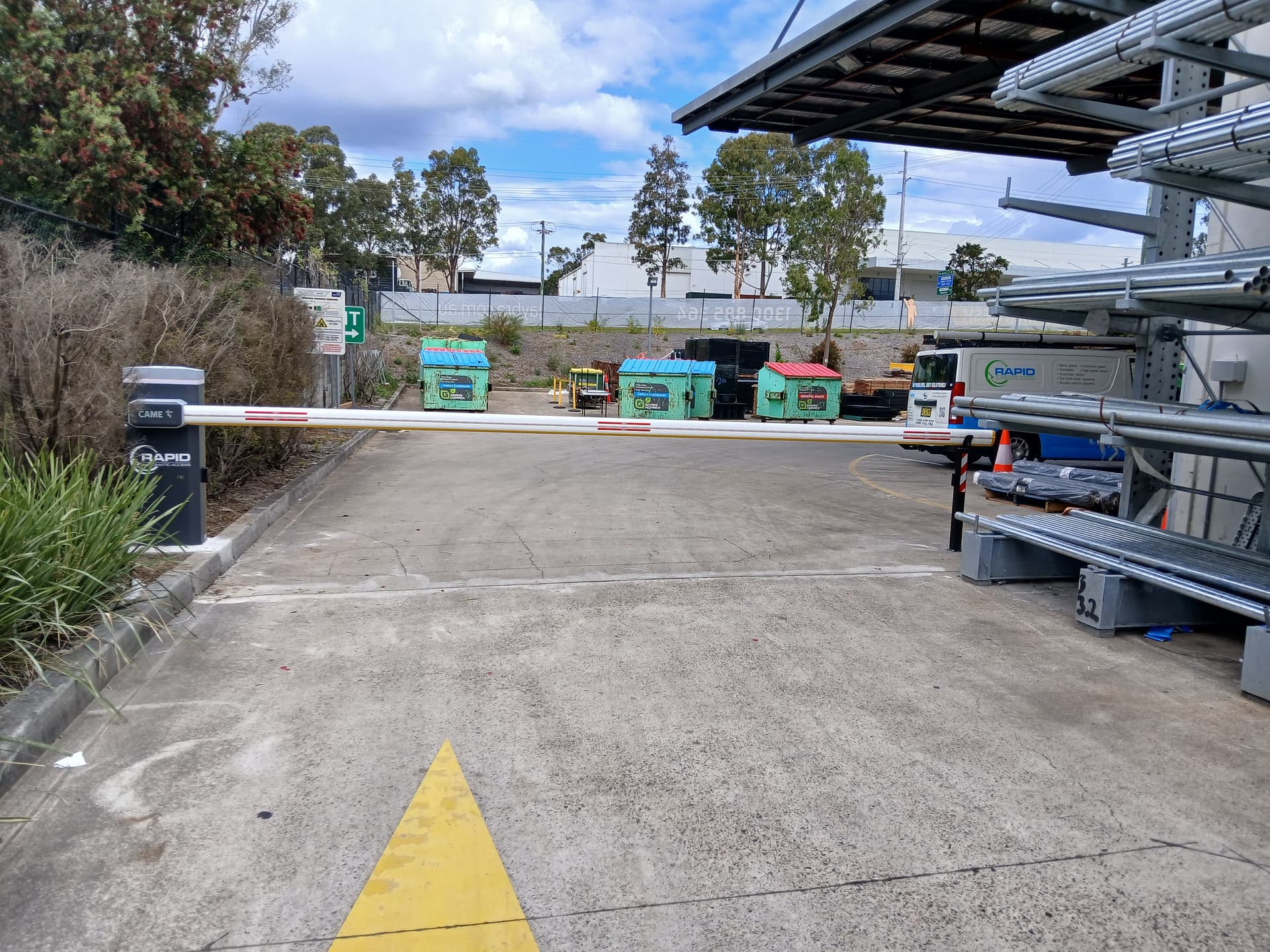 Fixed boom gate controlling the entrance to an industrial supply yard