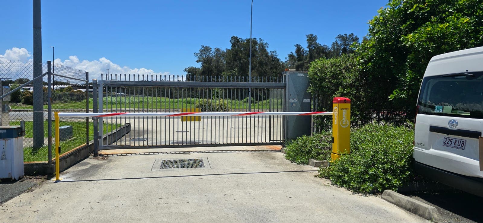 Rapid Sector boom gate closed across an industrial site entrance.