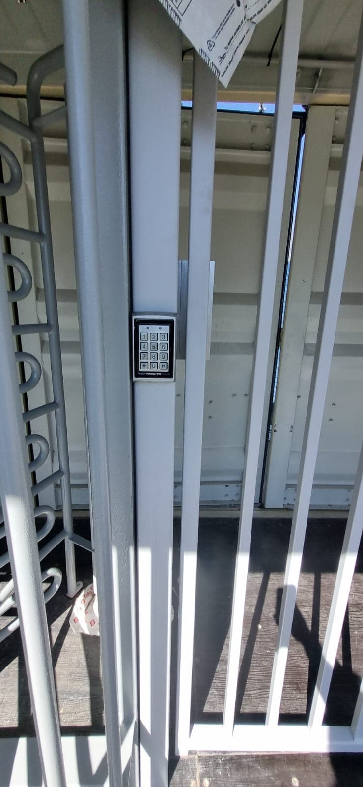 Turnstile entrance with keypad and access control reader.