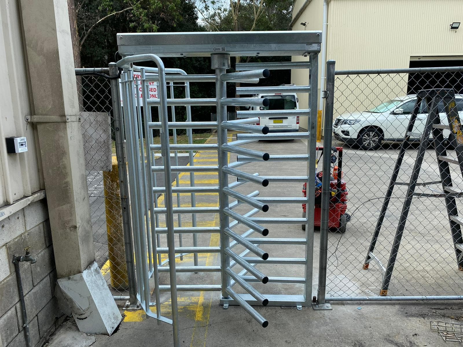 Galvanized full-height turnstile at an industrial access point