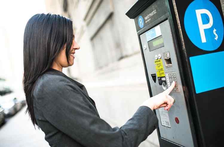 Woman using a parking machine.