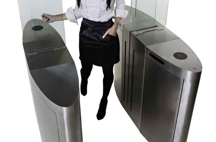 Woman using a speed gate at a train station.