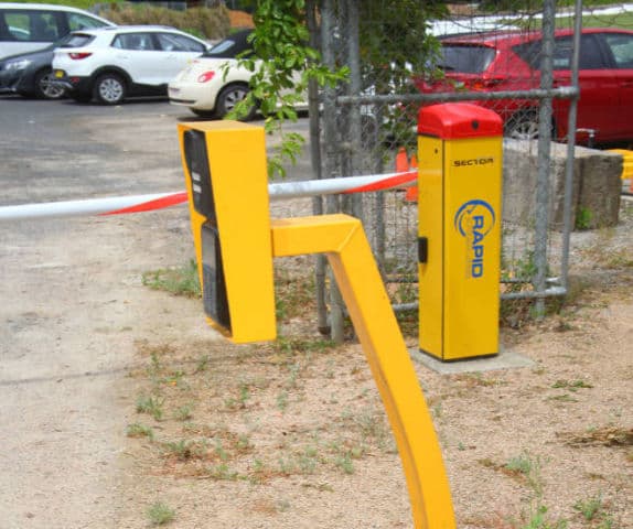 Close-up of a wireless GSM intercom to control the boom gate behind it.