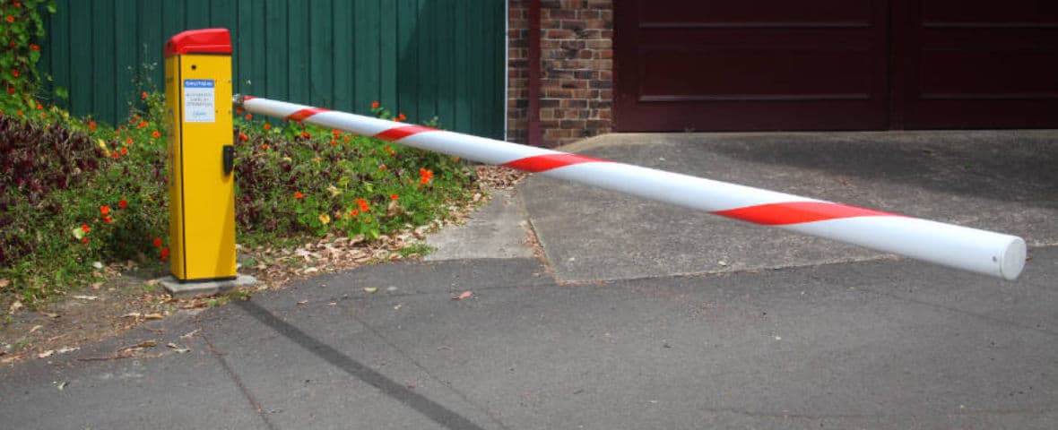 Close-up of a sector boom gate arm at the entry of a car park.