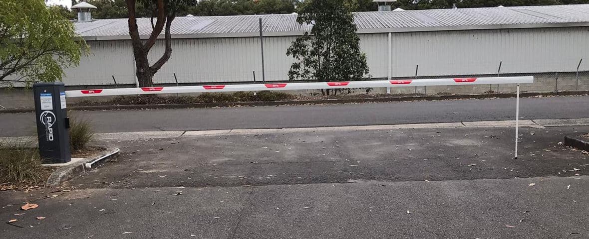 Closed Rapid Maxima boom gate at the entry of a staff car park.