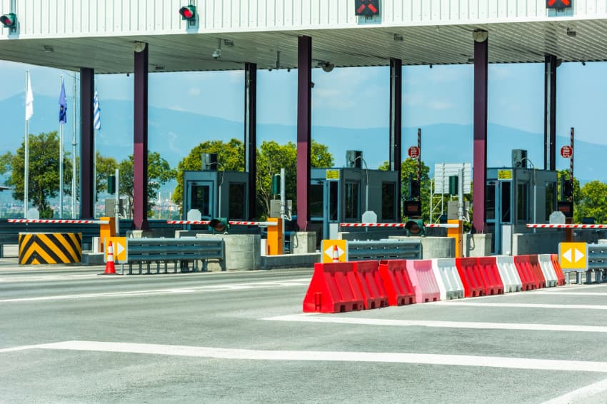 Photo of several boom gates at a highway toll booth.