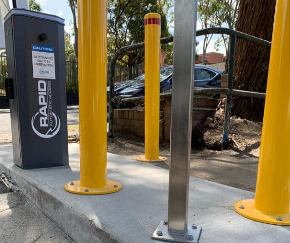 Close-up of a boom gate arm completely open at the entry of a hotel car park.