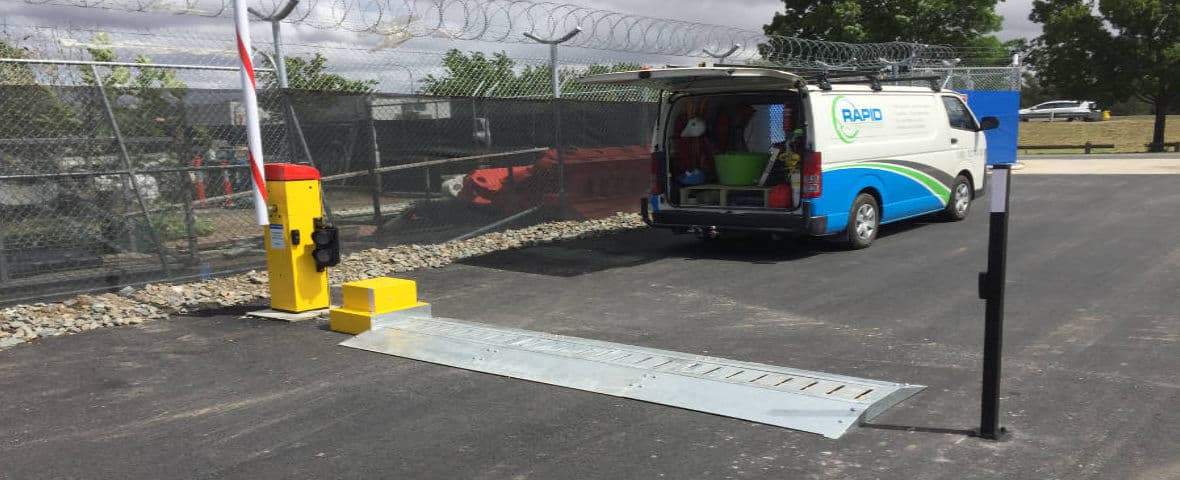 Rapid Automatic technicians working on the installation of a boom gate, tiger spikes and traffic light.