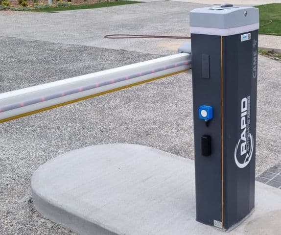 Close-up of a boom gate arm at the entry of a retirement village.
