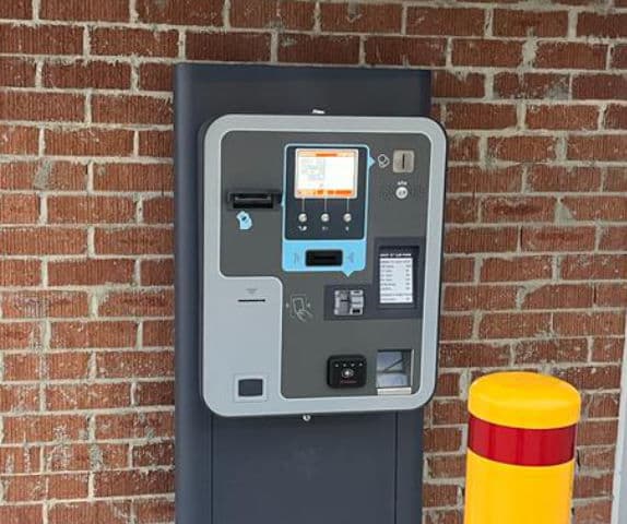 Close-up of an integrated cashless payment system stand-alone wall unit.