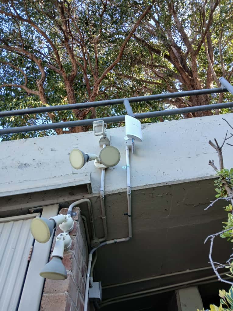 Security flood lights installed to support camera coverage at a monitored property.