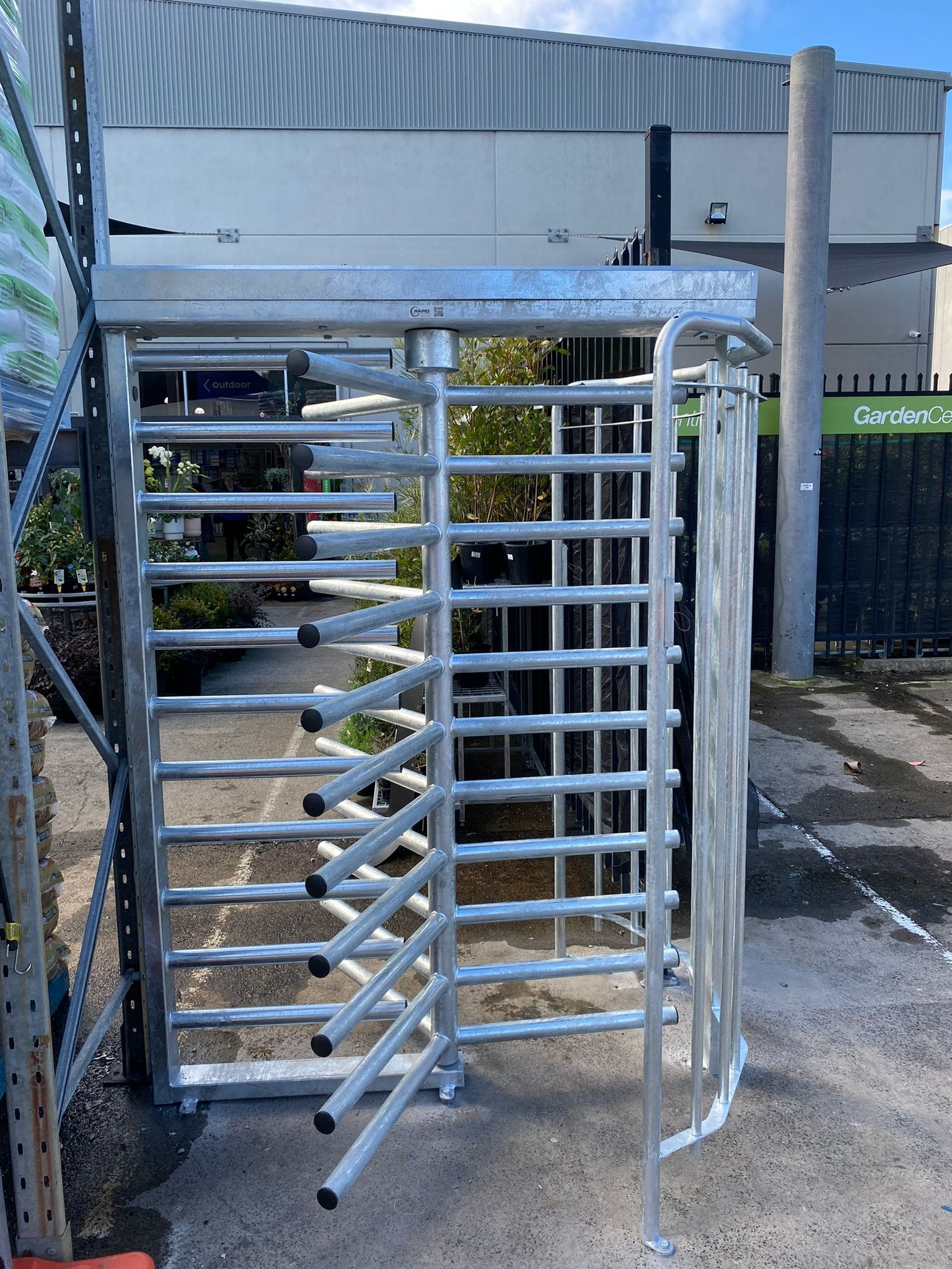 Commercial turnstile installed at a secure facility entrance.