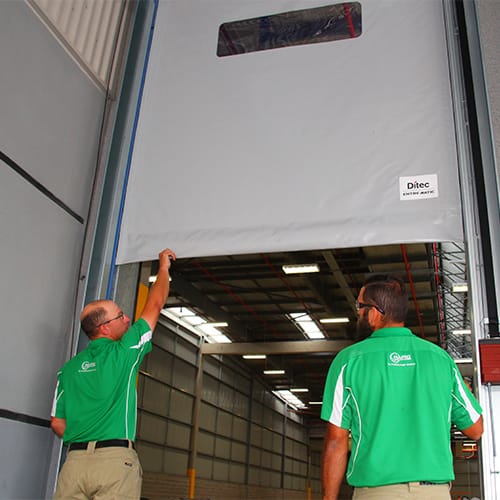 Rapid technicians servicing a high-speed industrial door.