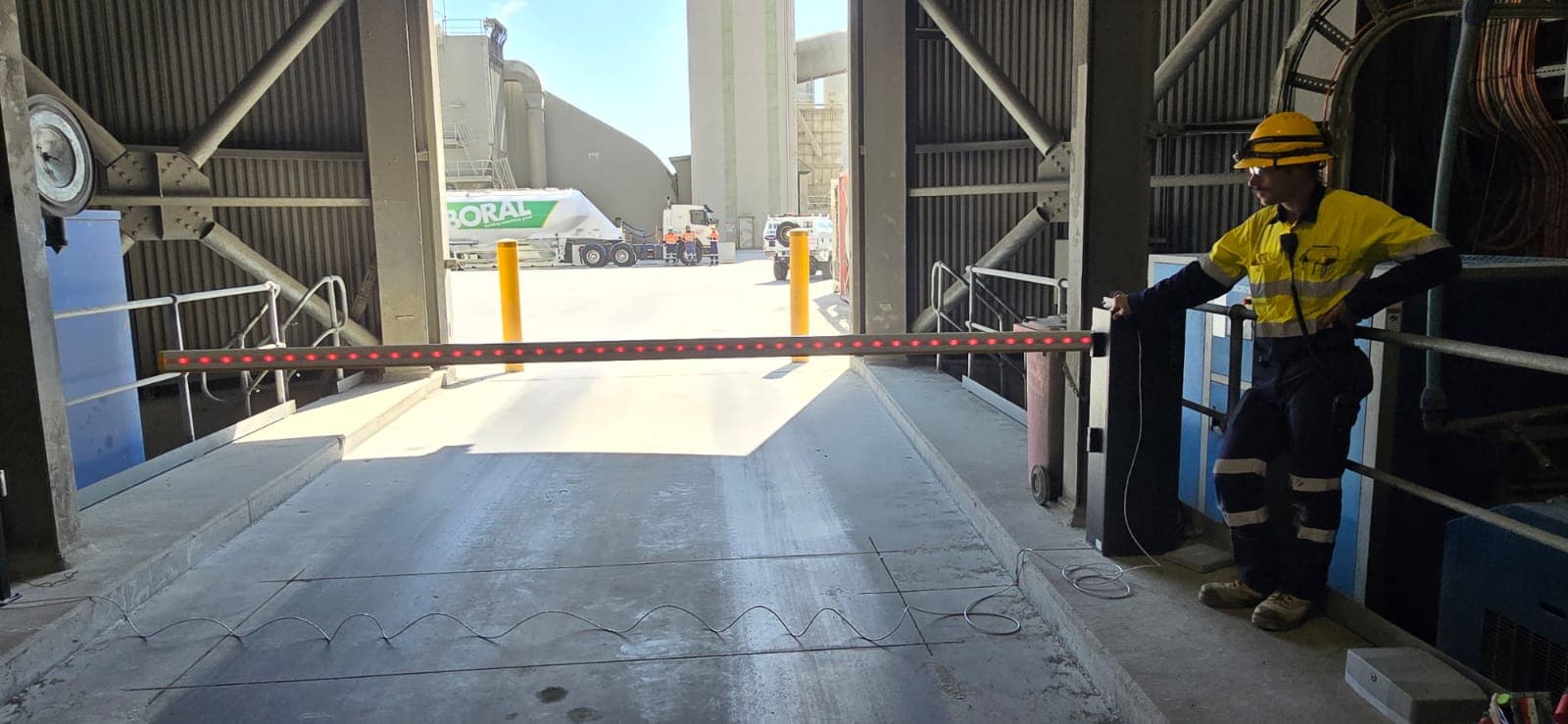 Technician testing a boom gate during planned maintenance.