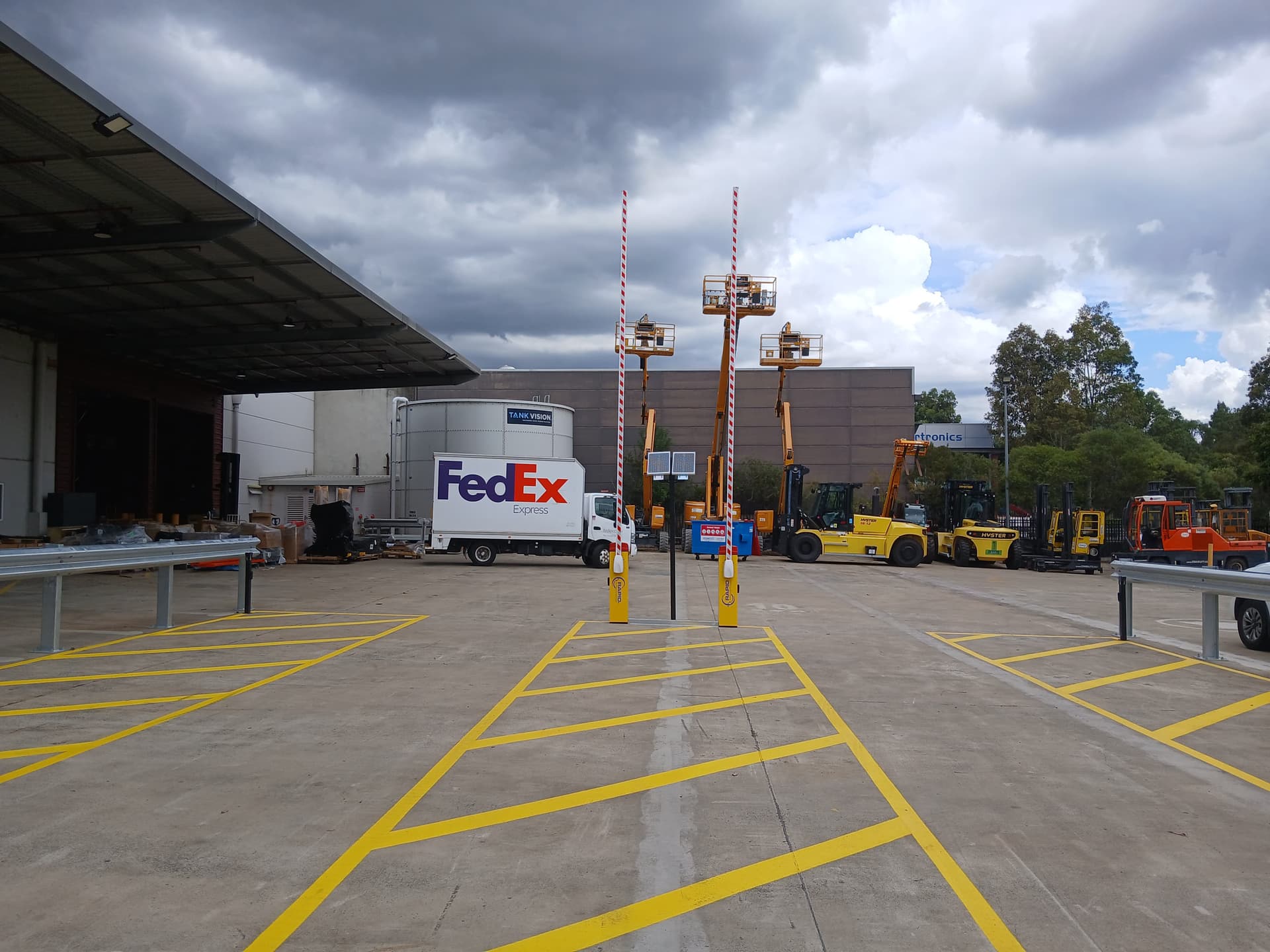 Dual Rapid boom-gate control posts with forklifts at a logistics facility