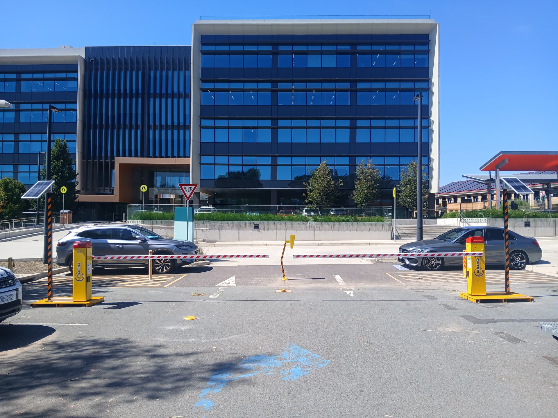 Dual boom gates controlling vehicle entry and exit.