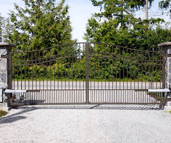 A double swing gate with a keypad entry system.