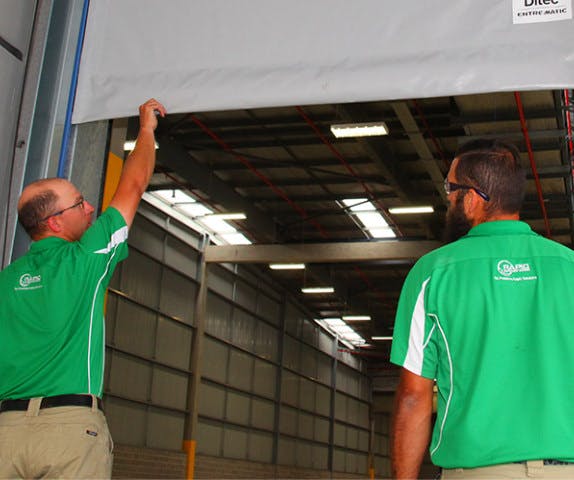 Rapid Automatic technicians working on the installation of a high speed door.