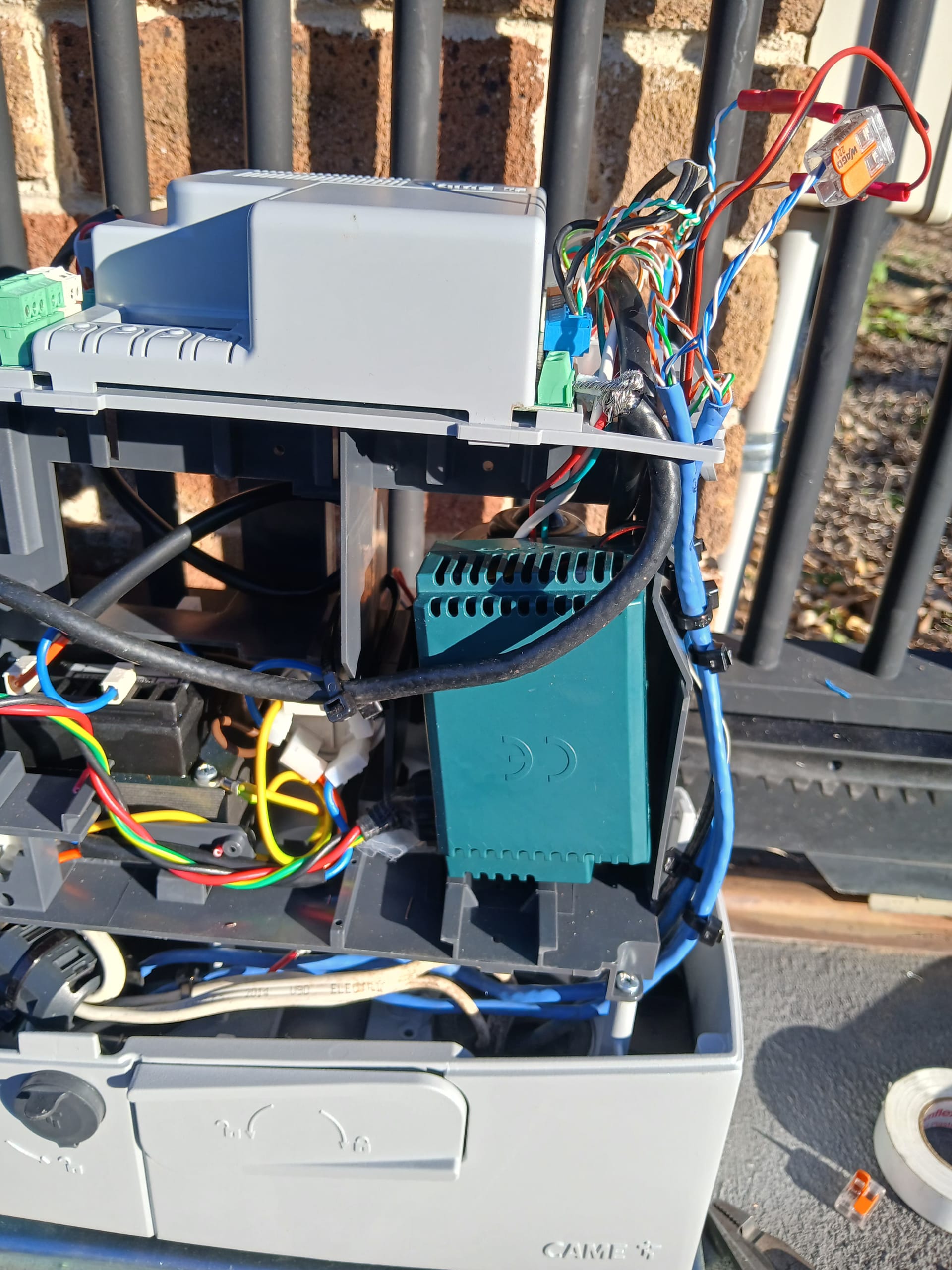 Open automatic sliding gate motor wiring inspected during fault diagnosis.
