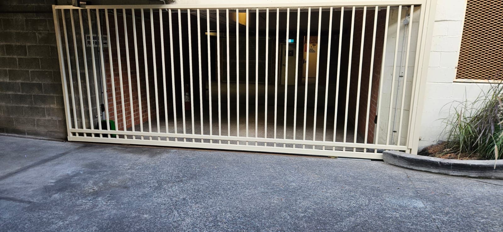 Wide sliding gate installed across an indoor car park entrance.