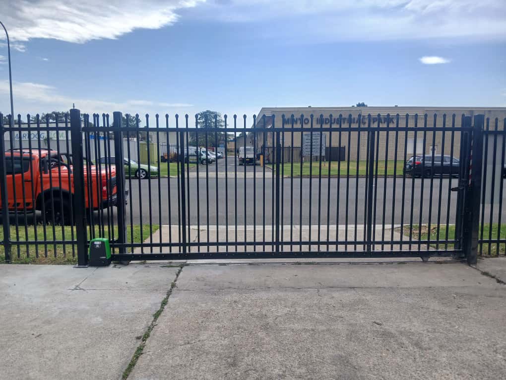 Industrial sliding gate controlling a warehouse yard entry.