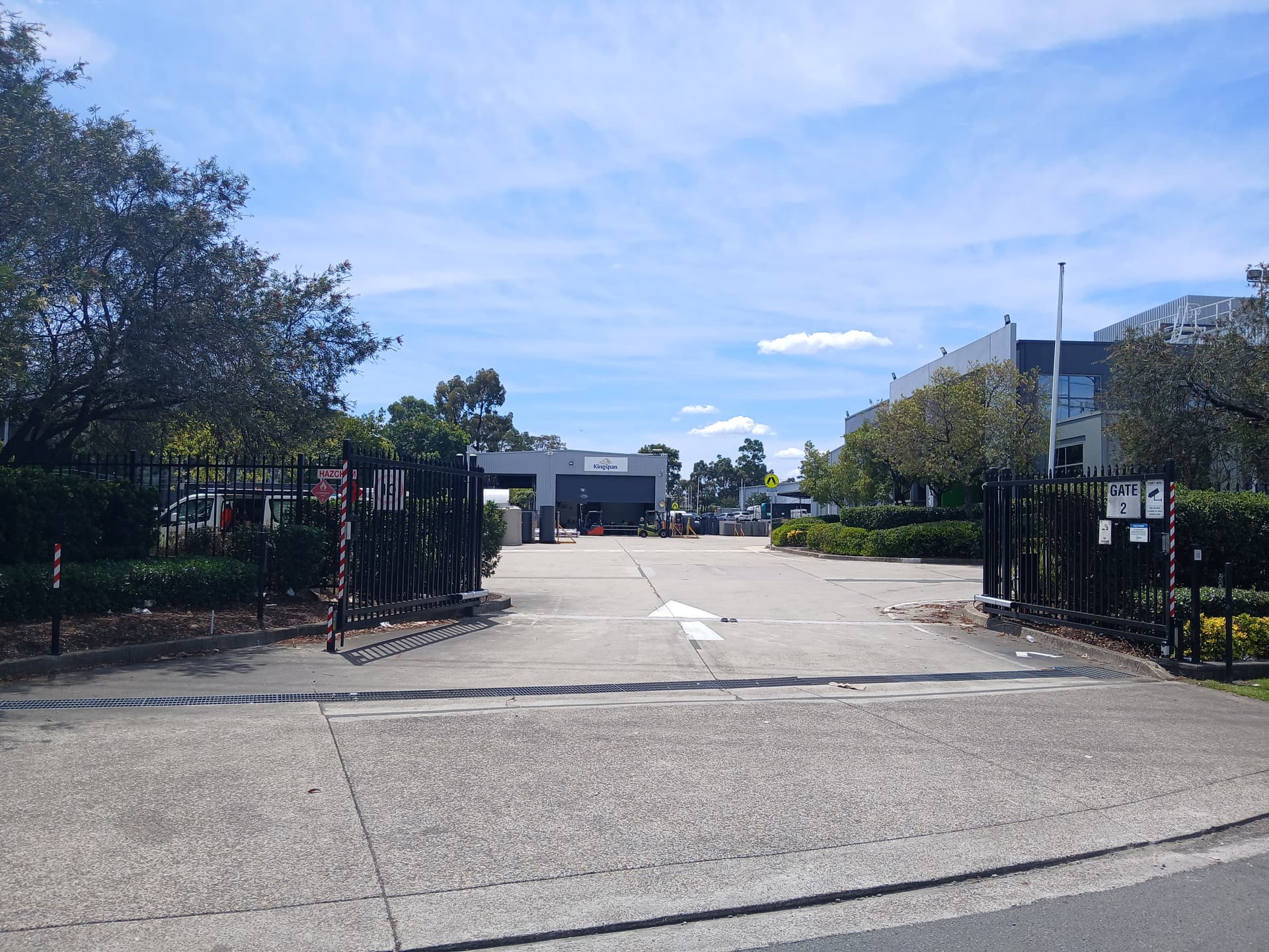 Commercial double swing gates at a facility entrance.