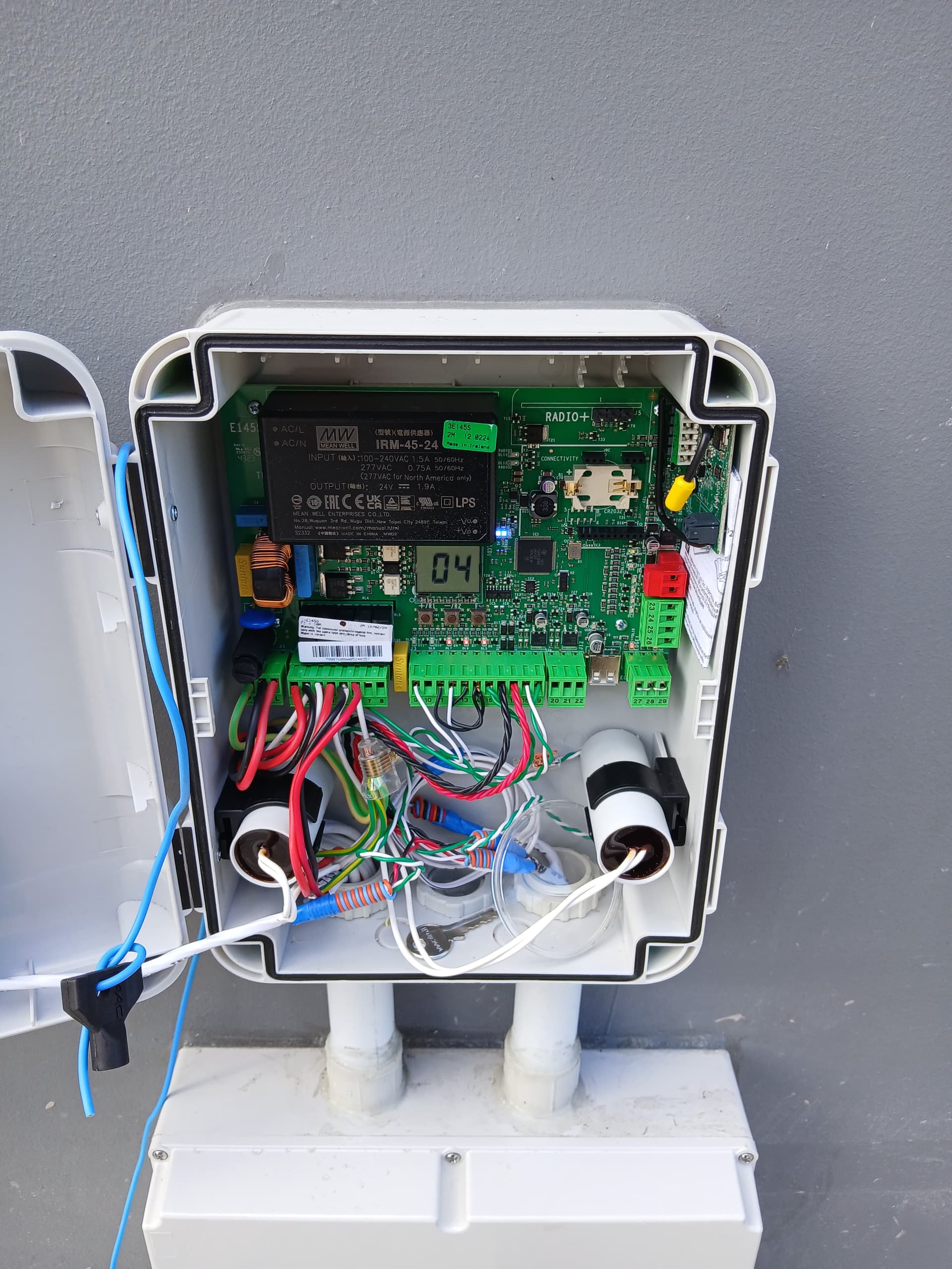 Open automatic-gate control enclosure showing circuit boards and wiring