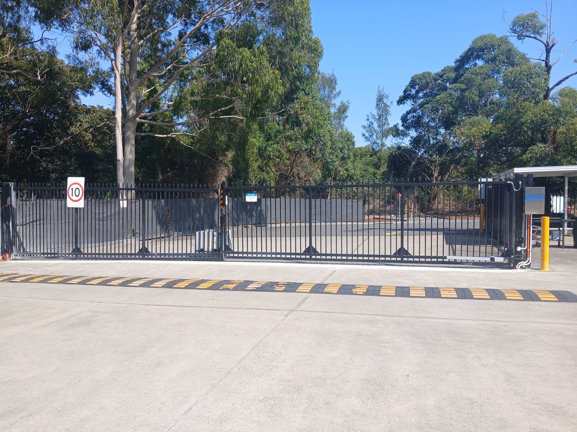 Custom vehicle access gates at a controlled entrance.