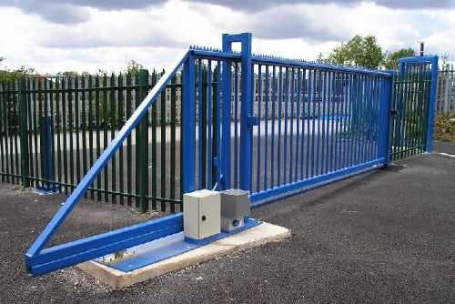 A blue cantilever gate at an industrial complex.