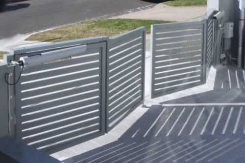 A silver bi-fold swing gate at a residential home.