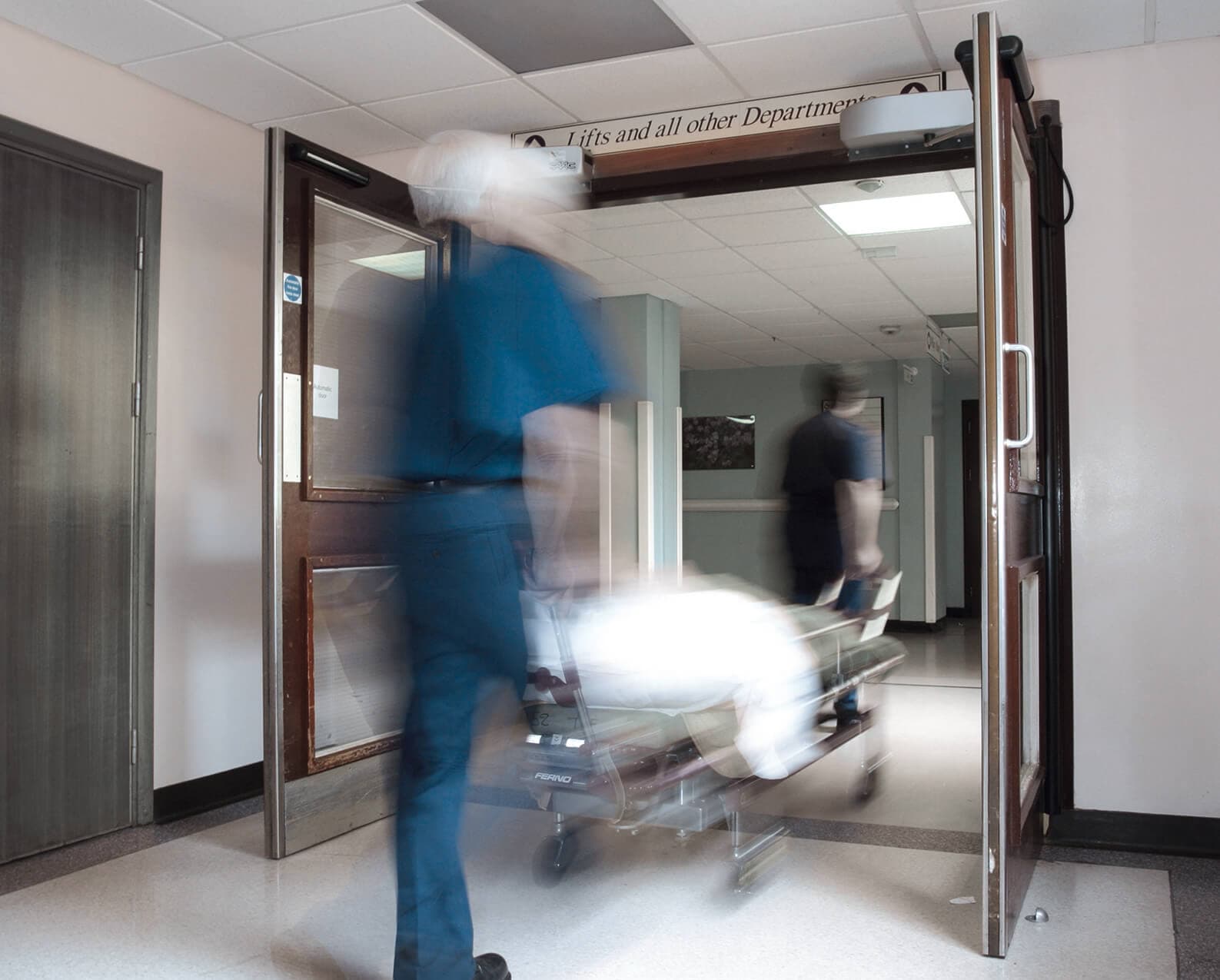 Automatic swing door operator fitted to a hospital entry door.