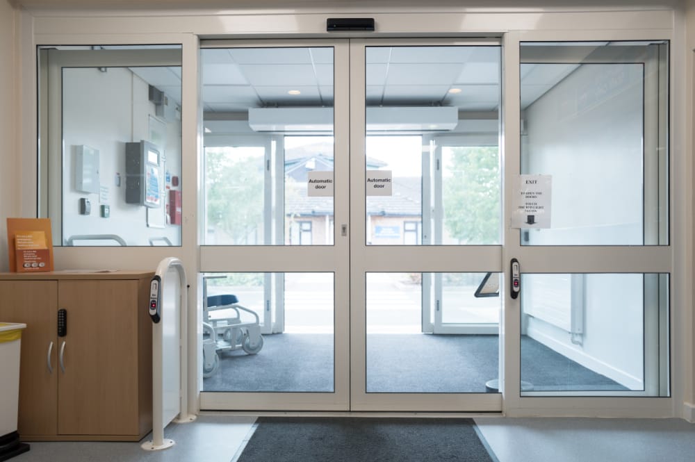 Automatic glass doors at a commercial building entrance.