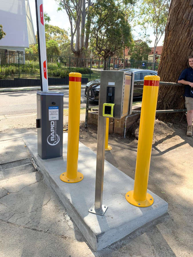 Coin and EFTPOS boom gate payment system for car park access.