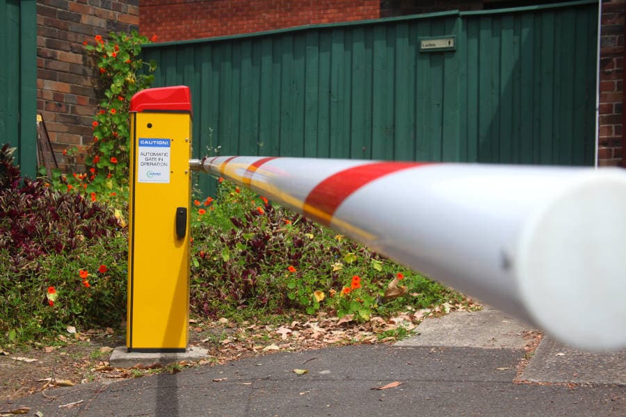 Close-up of a boom gate arm requiring service or repair.