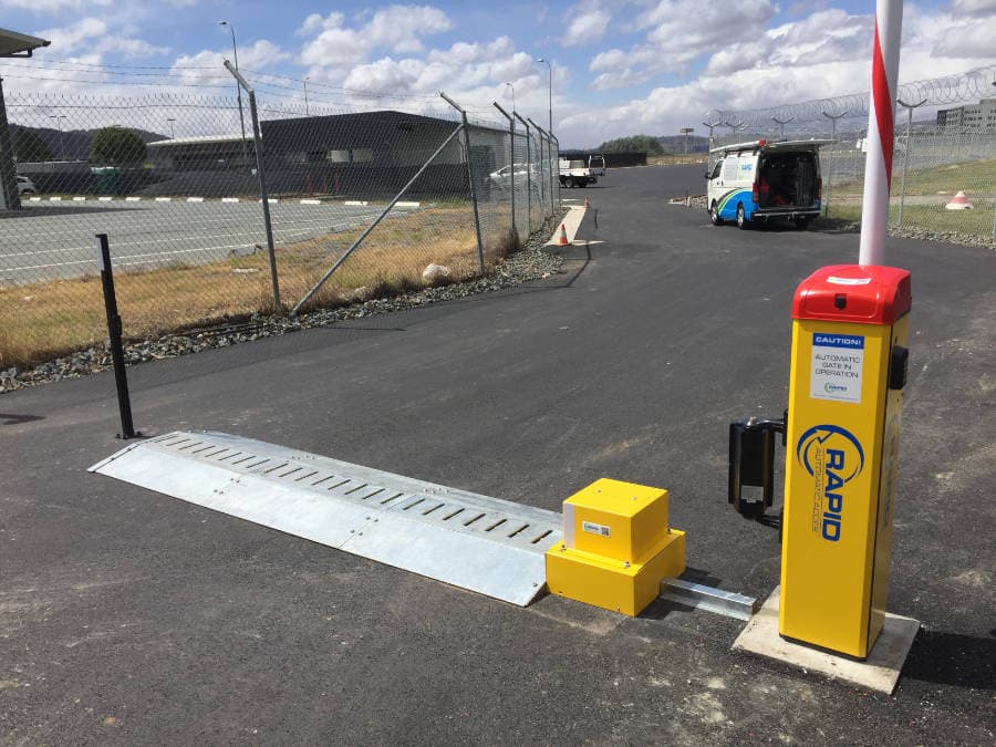Boom gate safety sensor and barrier installed at a vehicle entry.