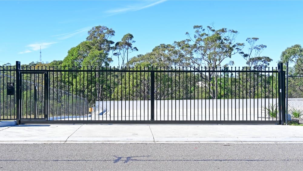 Industrial sliding gate with separate pedestrian access.